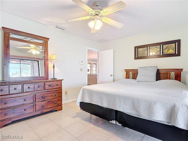 bedroom with ceiling fan and light tile patterned floors