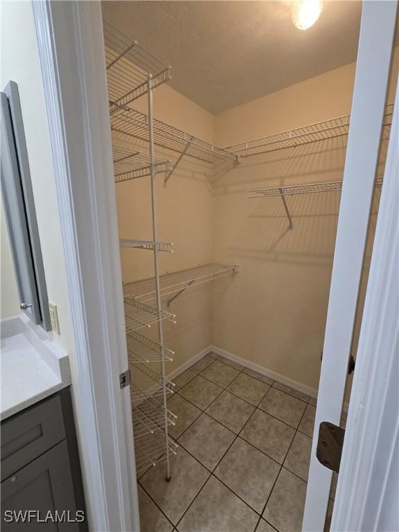 spacious closet featuring light tile patterned floors