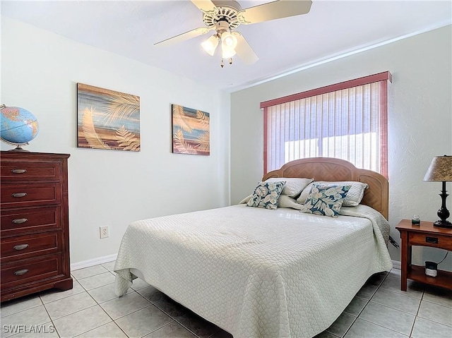 tiled bedroom with ceiling fan