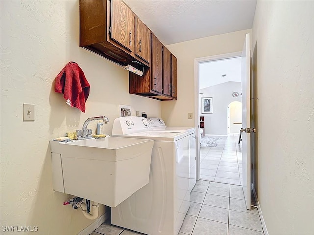 laundry room featuring cabinets, independent washer and dryer, sink, and light tile patterned flooring