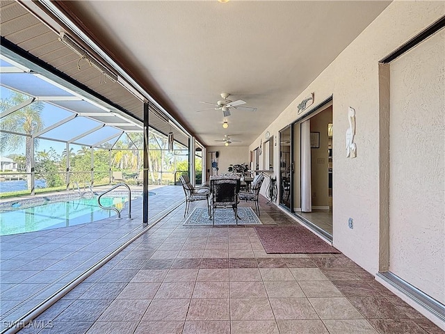 view of patio / terrace featuring ceiling fan and a lanai