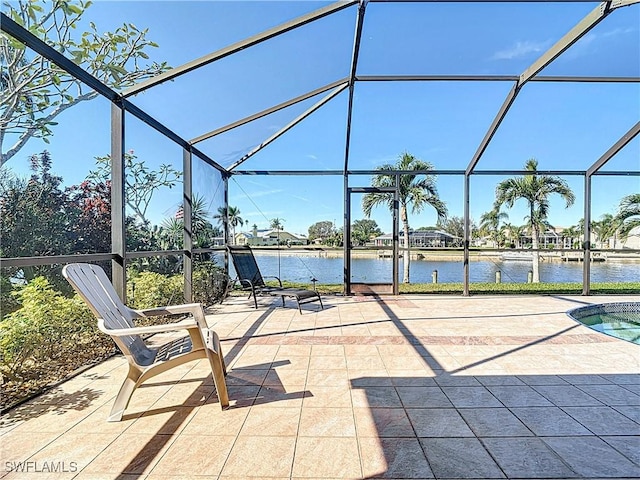 view of patio featuring a water view and a lanai