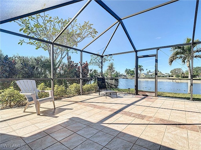 view of patio / terrace featuring a lanai and a water view