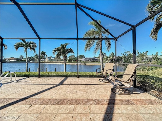 view of patio / terrace with a lanai and a water view