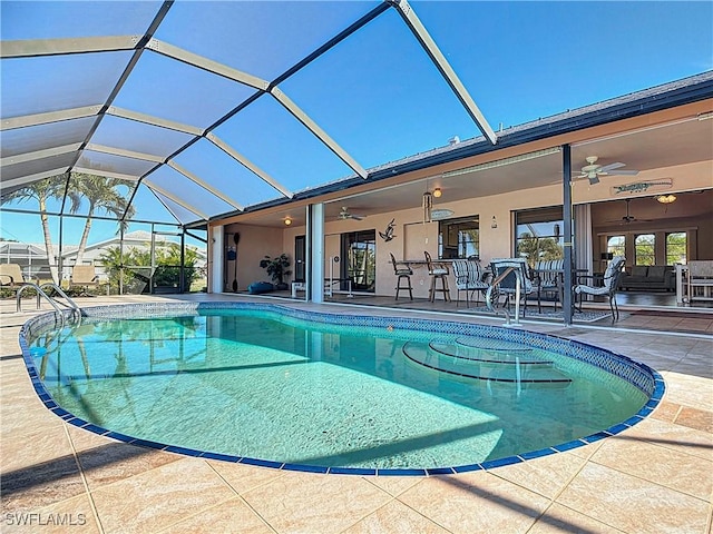 view of pool featuring a lanai, ceiling fan, and a patio