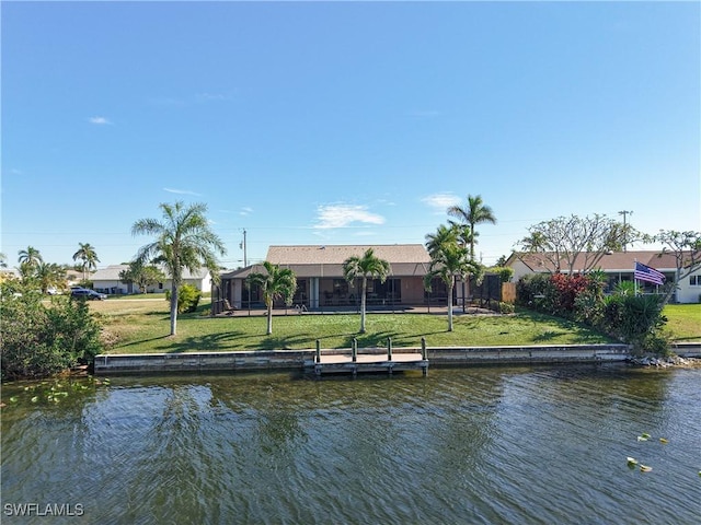 view of dock featuring a water view and a yard