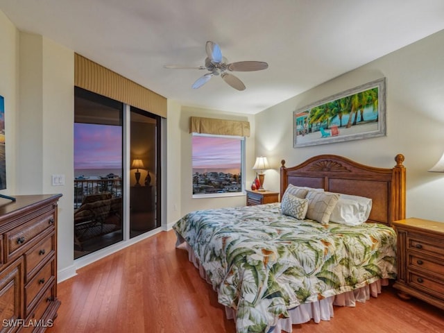 bedroom with access to outside, ceiling fan, and hardwood / wood-style flooring