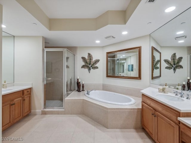 bathroom featuring tile patterned floors, vanity, and shower with separate bathtub