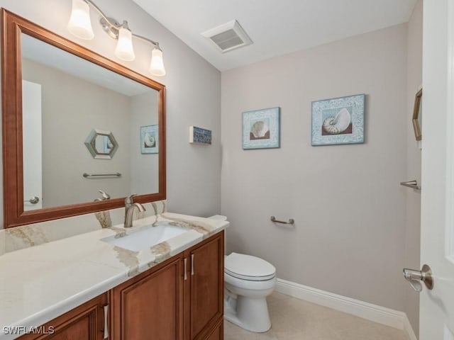 bathroom featuring tile patterned floors, vanity, and toilet