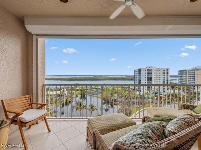 balcony with a water view and ceiling fan