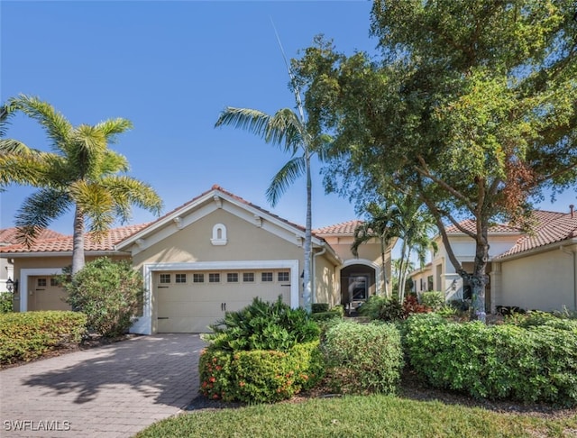 mediterranean / spanish house featuring a garage