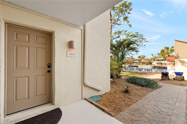 doorway to property featuring a water view