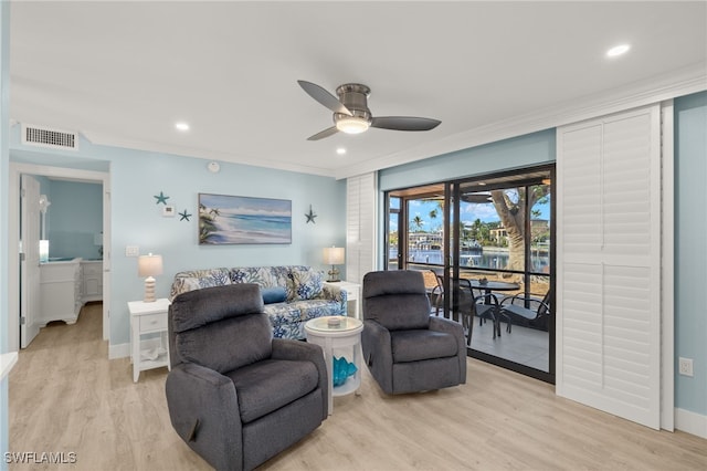 living room with ceiling fan, light wood-type flooring, and ornamental molding