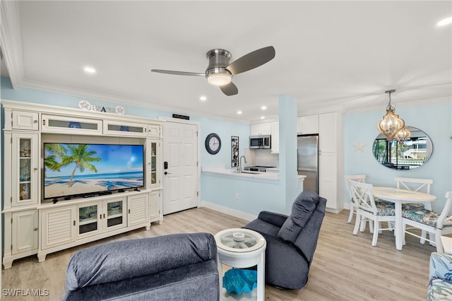 living room featuring crown molding, light hardwood / wood-style floors, and ceiling fan with notable chandelier