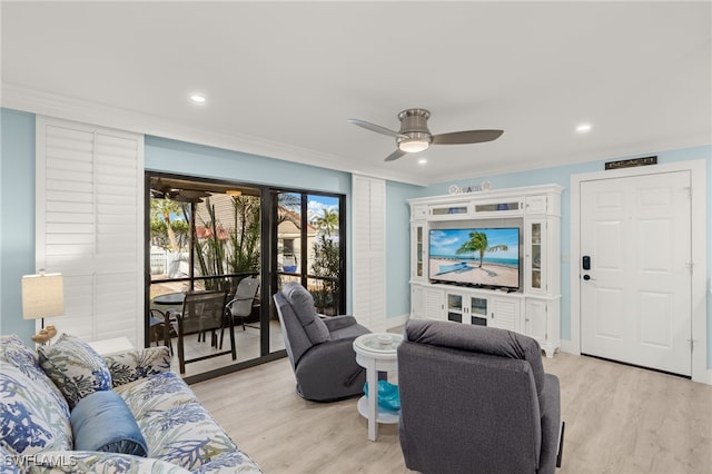 living room featuring ceiling fan, light wood-type flooring, and ornamental molding