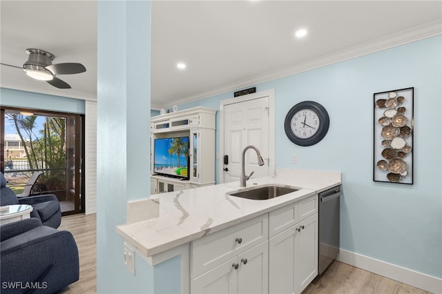 kitchen with light stone countertops, sink, light hardwood / wood-style flooring, stainless steel dishwasher, and white cabinets