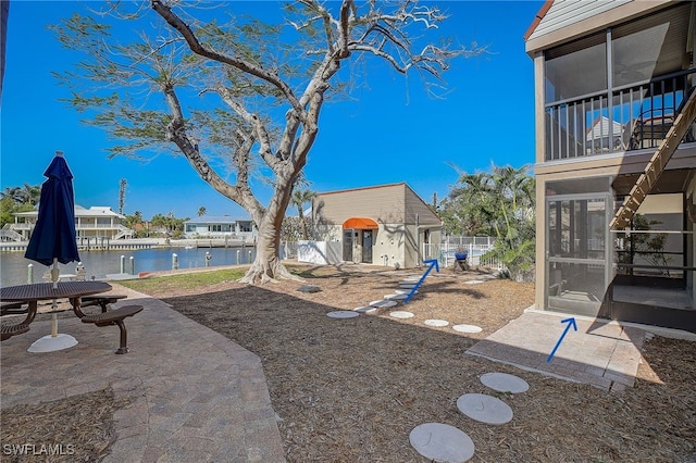 view of yard with an outbuilding and a water view