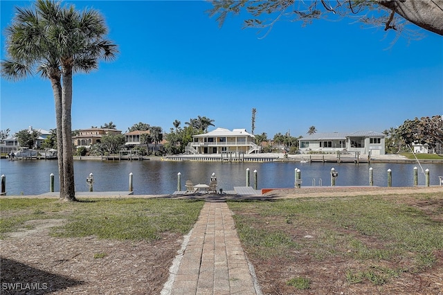 dock area featuring a yard and a water view