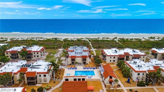 drone / aerial view featuring a water view and a view of the beach