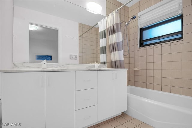 bathroom with shower / bath combo with shower curtain, vanity, and tile patterned flooring