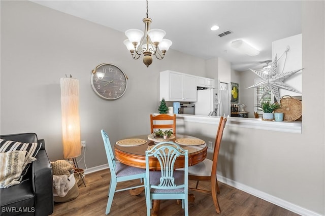 dining room featuring hardwood / wood-style flooring and a notable chandelier