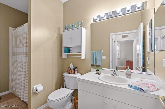 bathroom featuring toilet and vanity