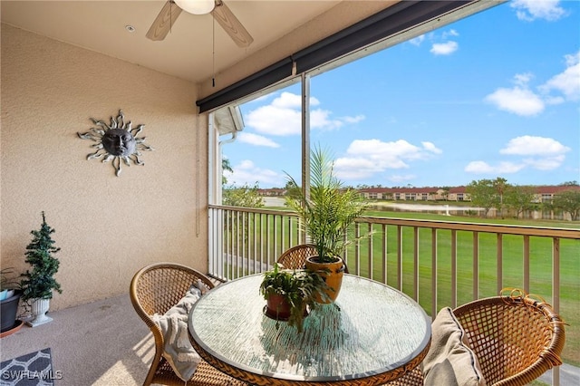 sunroom / solarium featuring ceiling fan