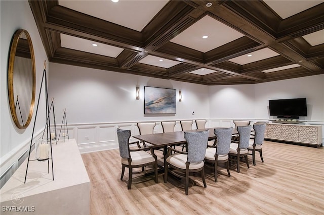 dining area with light hardwood / wood-style floors, beam ceiling, and coffered ceiling