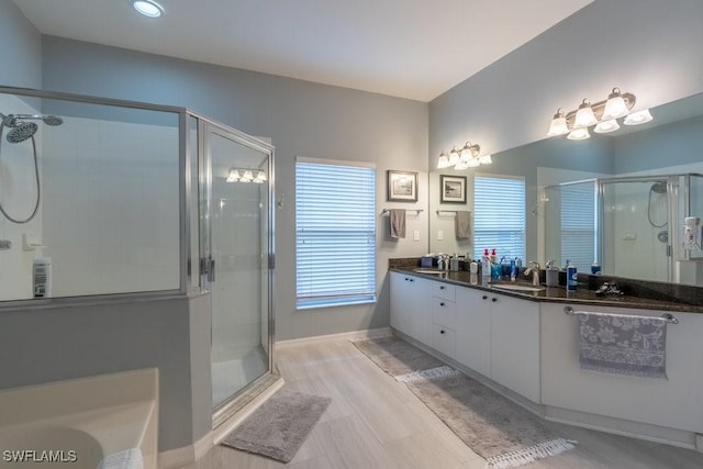 bathroom with vanity and independent shower and bath