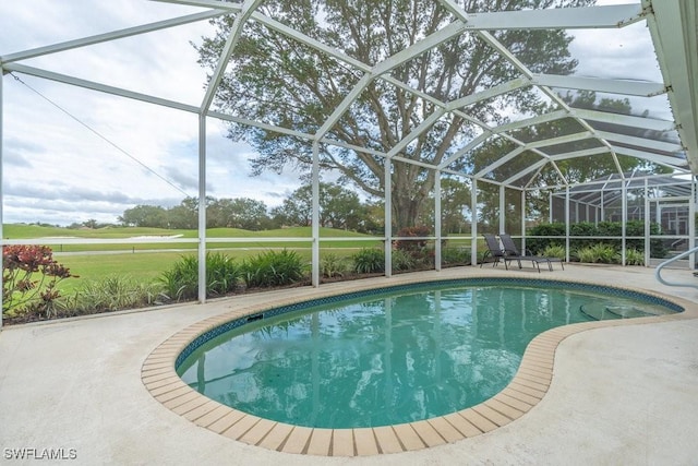 view of swimming pool featuring glass enclosure and a patio area