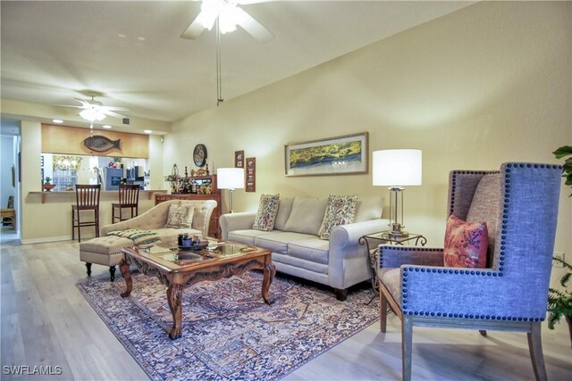 living room featuring ceiling fan and light wood-type flooring