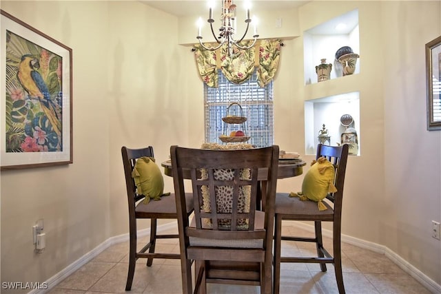 tiled dining space featuring an inviting chandelier