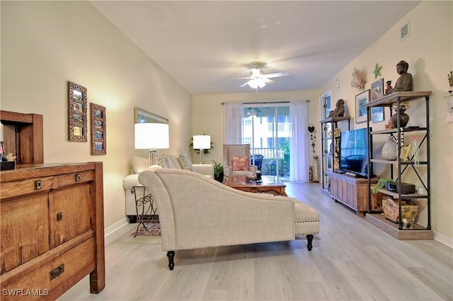 living room with light wood-type flooring and ceiling fan