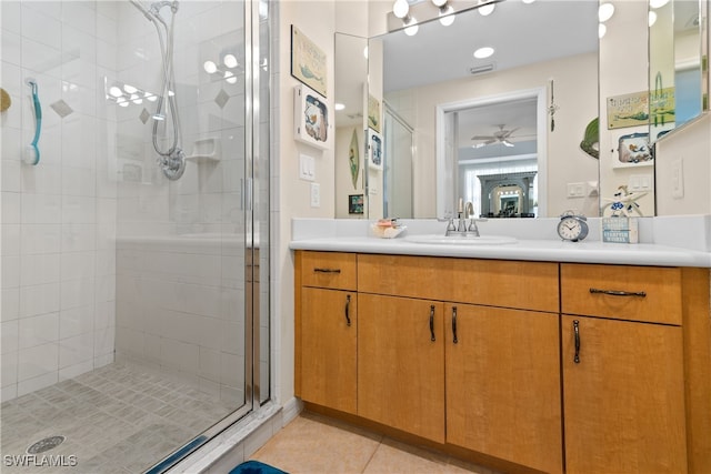 bathroom with tile patterned floors, vanity, ceiling fan, and walk in shower