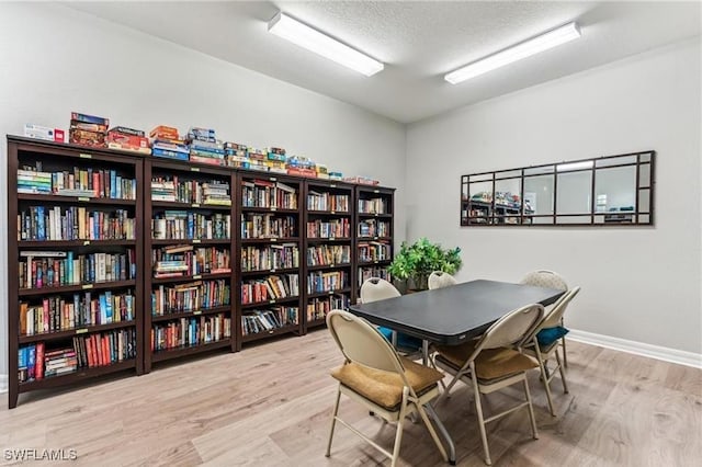 interior space featuring light hardwood / wood-style flooring and a textured ceiling