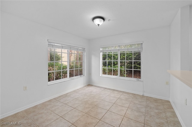 unfurnished room featuring light tile patterned floors