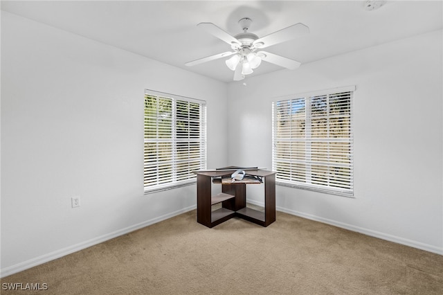 office area featuring light carpet and ceiling fan