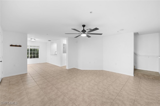 tiled empty room featuring ceiling fan