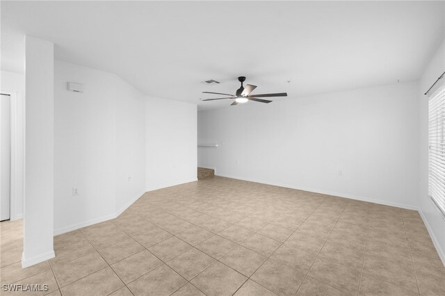 tiled empty room with ceiling fan