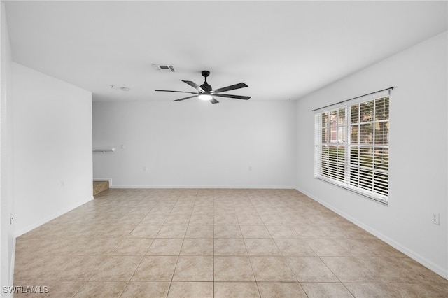 empty room featuring light tile patterned flooring and ceiling fan