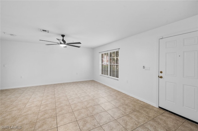 unfurnished room featuring light tile patterned floors and ceiling fan