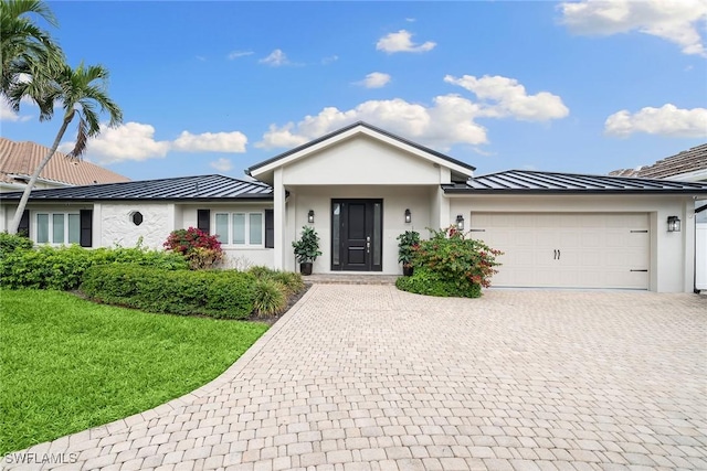 ranch-style home featuring a garage and a front yard