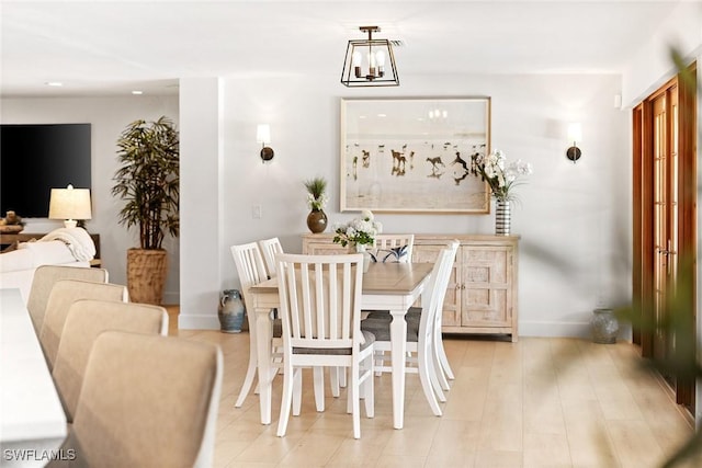 dining room with recessed lighting and baseboards