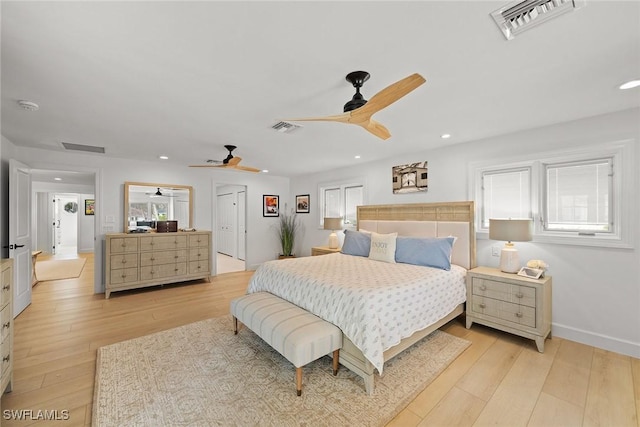 bedroom featuring light wood-style floors, multiple windows, and visible vents