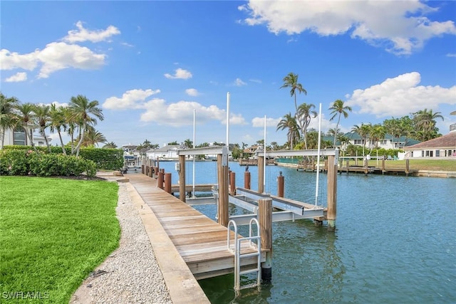 dock area with a lawn, a water view, and boat lift