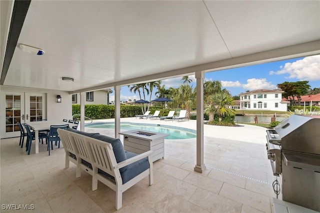 view of swimming pool featuring an outdoor fire pit, french doors, a patio area, and outdoor dining area