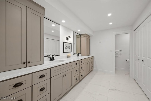 bathroom featuring recessed lighting, marble finish floor, and a sink