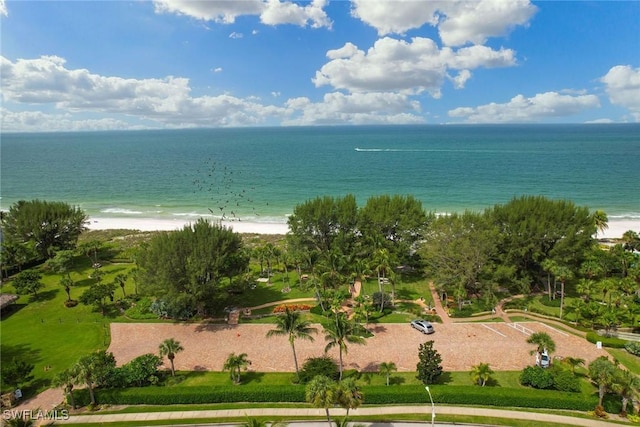 bird's eye view featuring a water view and a beach view