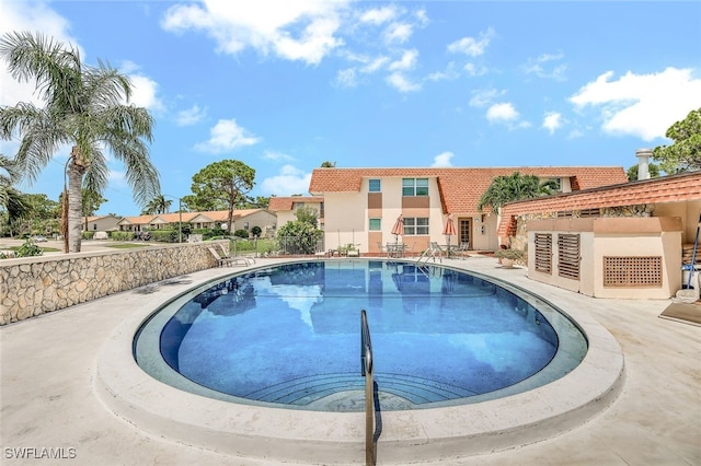 view of swimming pool with a patio area