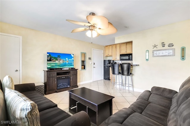 tiled living room with ceiling fan